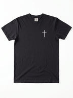 A black short-sleeve crewneck t-shirt with a small white Christian cross printed on the left chest, displayed flat against a white background.