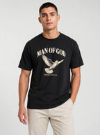Person wearing a black T-shirt with a flying dove and the text “Man of God” and “Romans 8:14.”