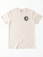 Cream T-shirt laid flat with a small circular dragon graphic and the text “VICTORY OVER DARKNESS” on the chest.