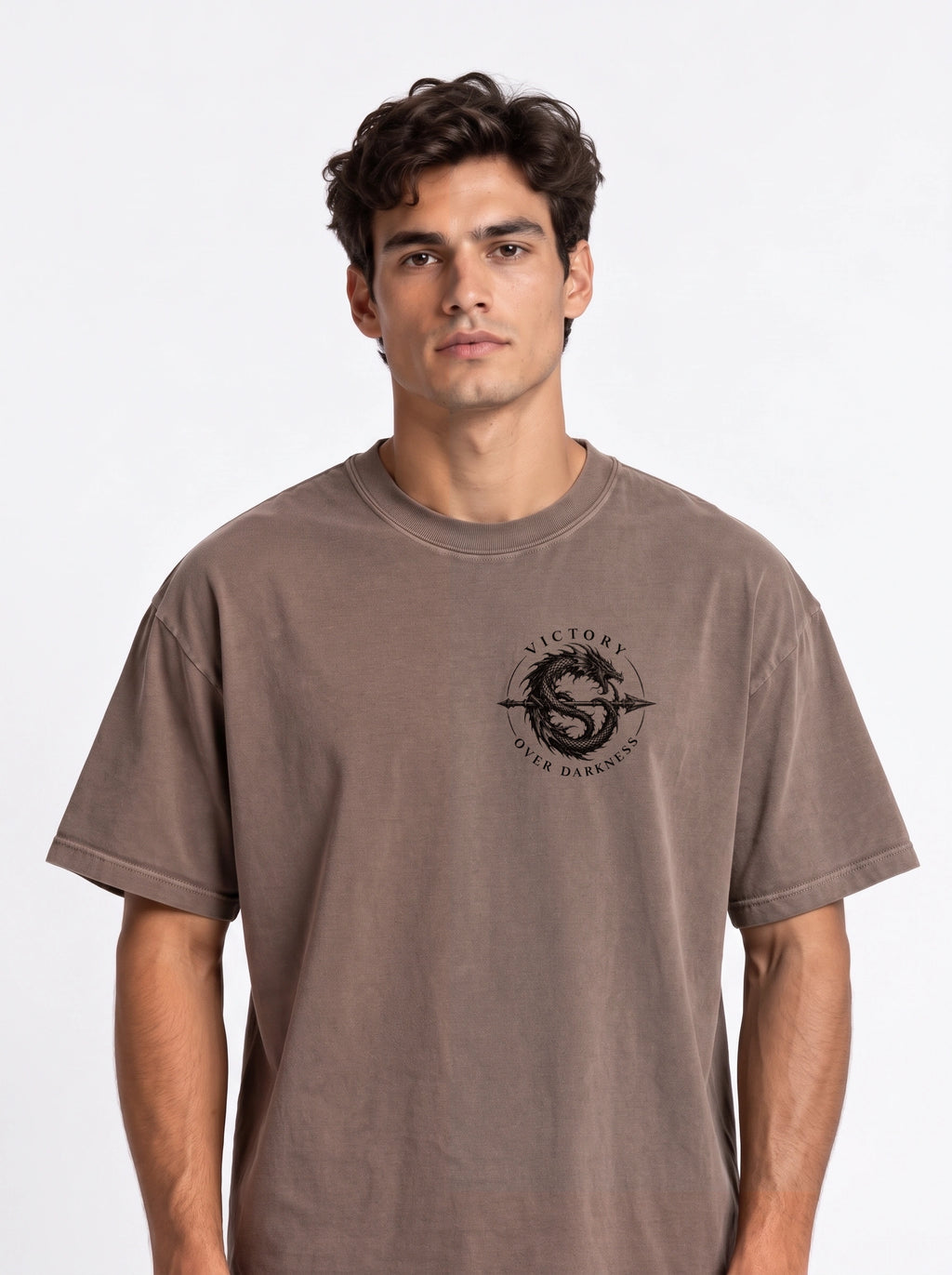 Brown T-shirt with a small circular dragon graphic and the text “VICTORY OVER DARKNESS” on the chest.