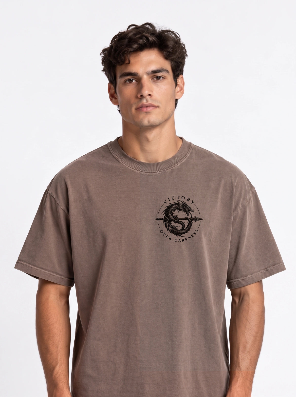Brown T-shirt with a small circular dragon graphic and the text “VICTORY OVER DARKNESS” on the chest.