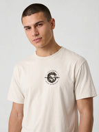 Cream T-shirt with a small circular dragon graphic and the text “VICTORY OVER DARKNESS” on the chest.