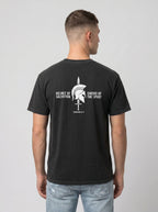 A man viewed from the back wearing a black t-shirt with a white graphic print of a Spartan helmet and sword, with the text 'HELMET OF SALVATION' and 'SWORD OF THE SPIRIT' on a light gray background.