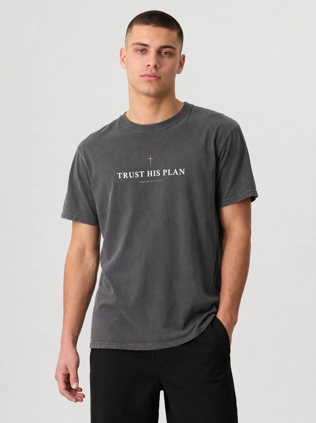 Man in dark gray Trust His Plan Christian t-shirt and black joggers, front view