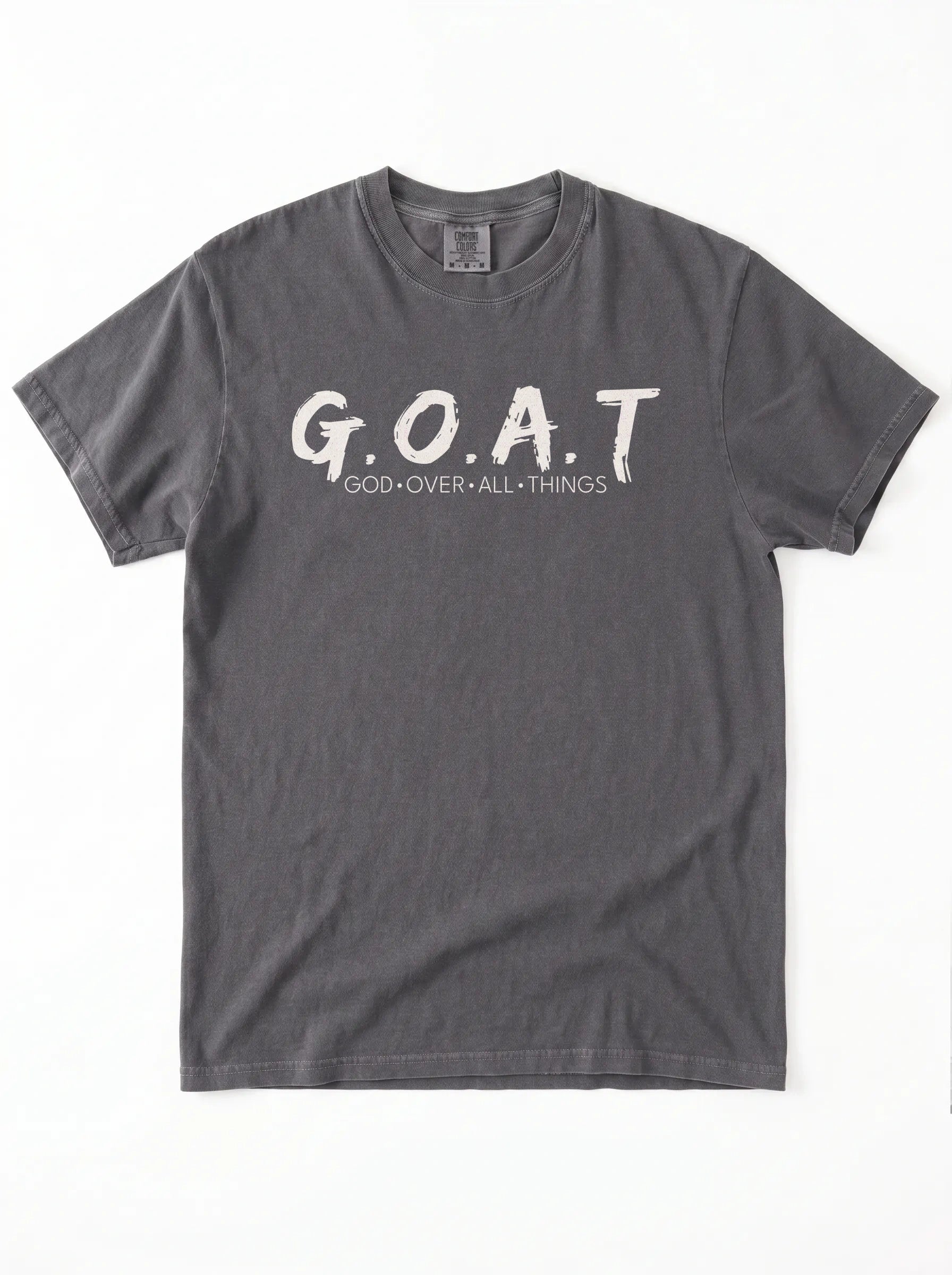 A dark gray short-sleeve t-shirt with 'G.O.A.T GOD OVER ALL THINGS' print across the chest.