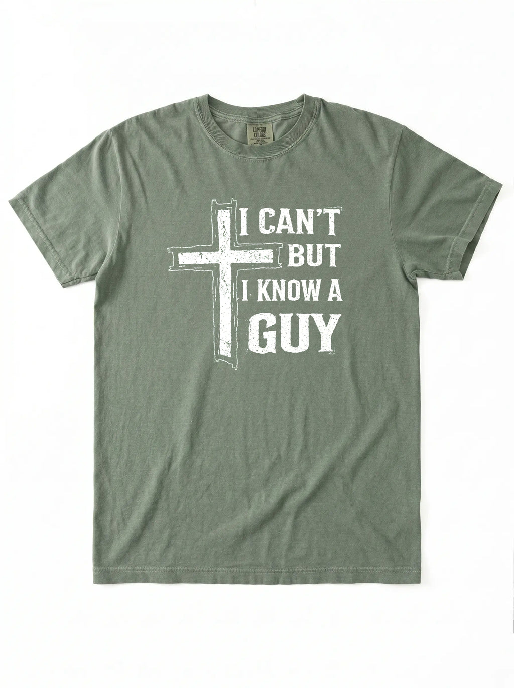 An olive green short-sleeve t-shirt with a white graphic print on the front featuring a distressed cross and the text 'I CAN'T BUT I KNOW A GUY'.
