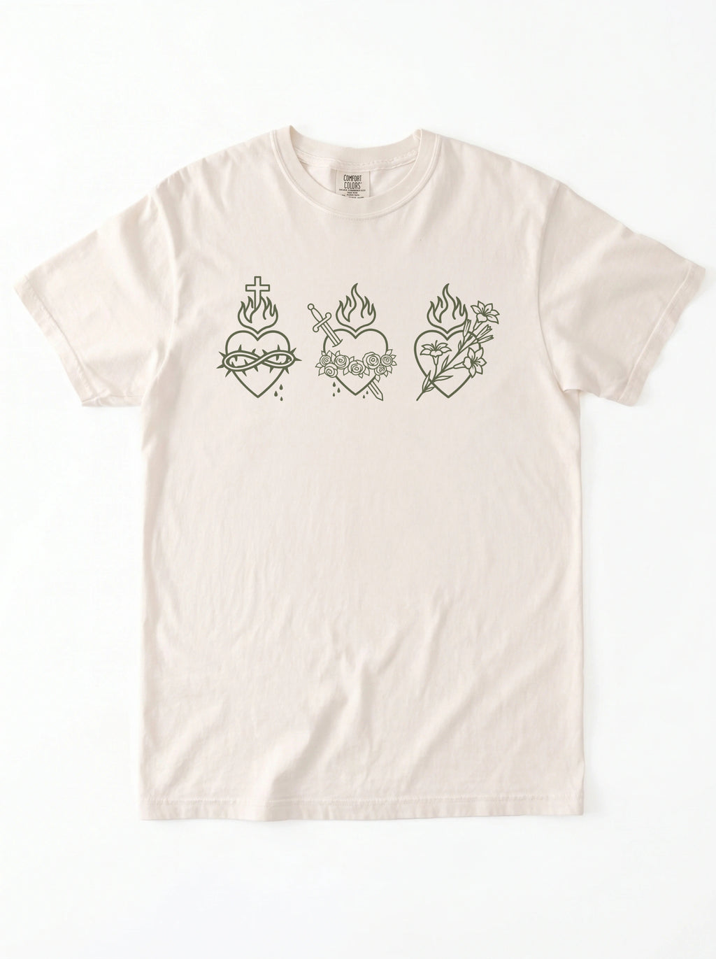 An off-white short-sleeve t-shirt with three dark green Sacred Heart line-art graphics across the chest, displayed flat against a white background.