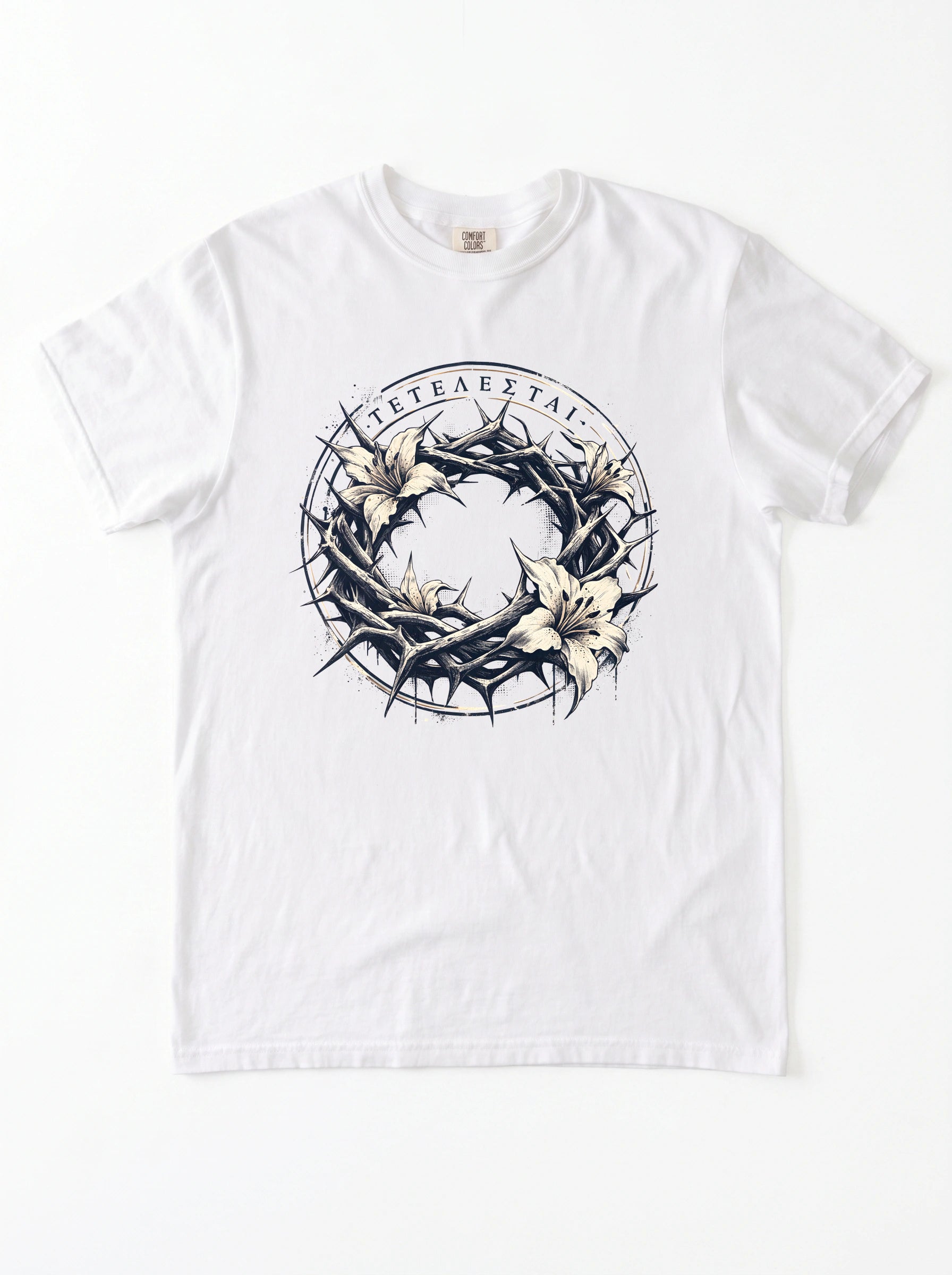 A white short-sleeve crewneck t-shirt featuring a graphic print of a crown of thorns and white lilies, featuring Greek text.