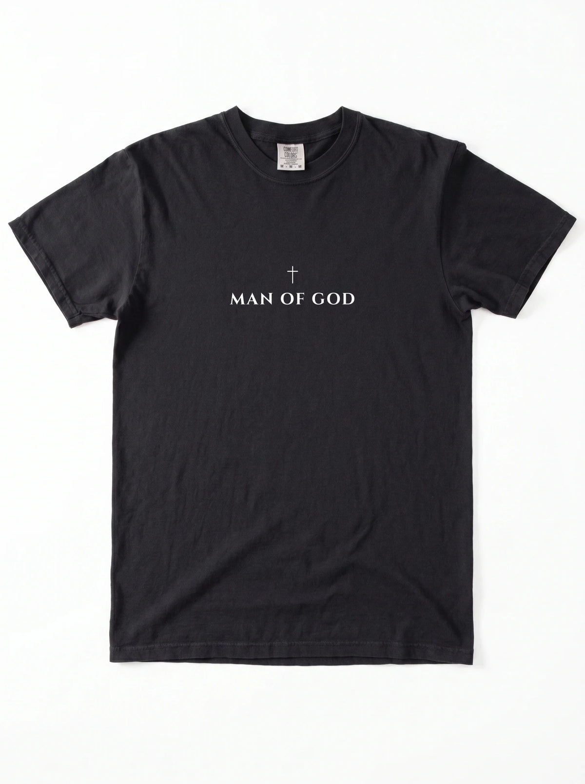 Black T-shirt laid flat with a small cross above the text “Man of God.”