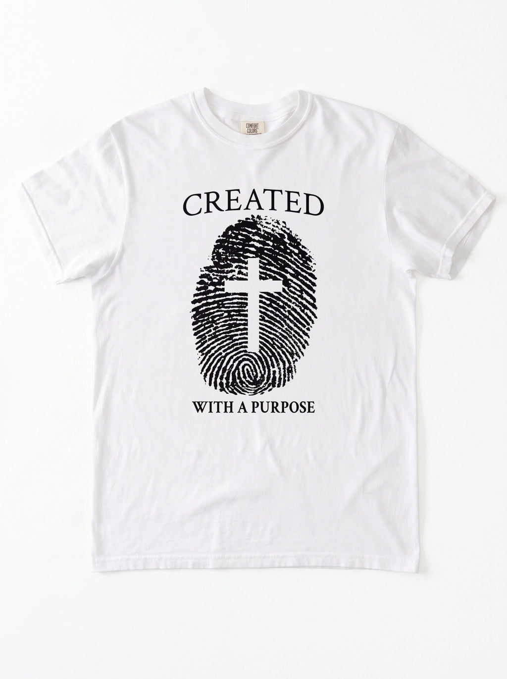 A white short-sleeve crewneck t-shirt with a black graphic print on the front. The graphic features the text 'CREATED WITH A PURPOSE' surrounding a fingerprint design where the center of the fingerprint is shaped like a Christian cross.