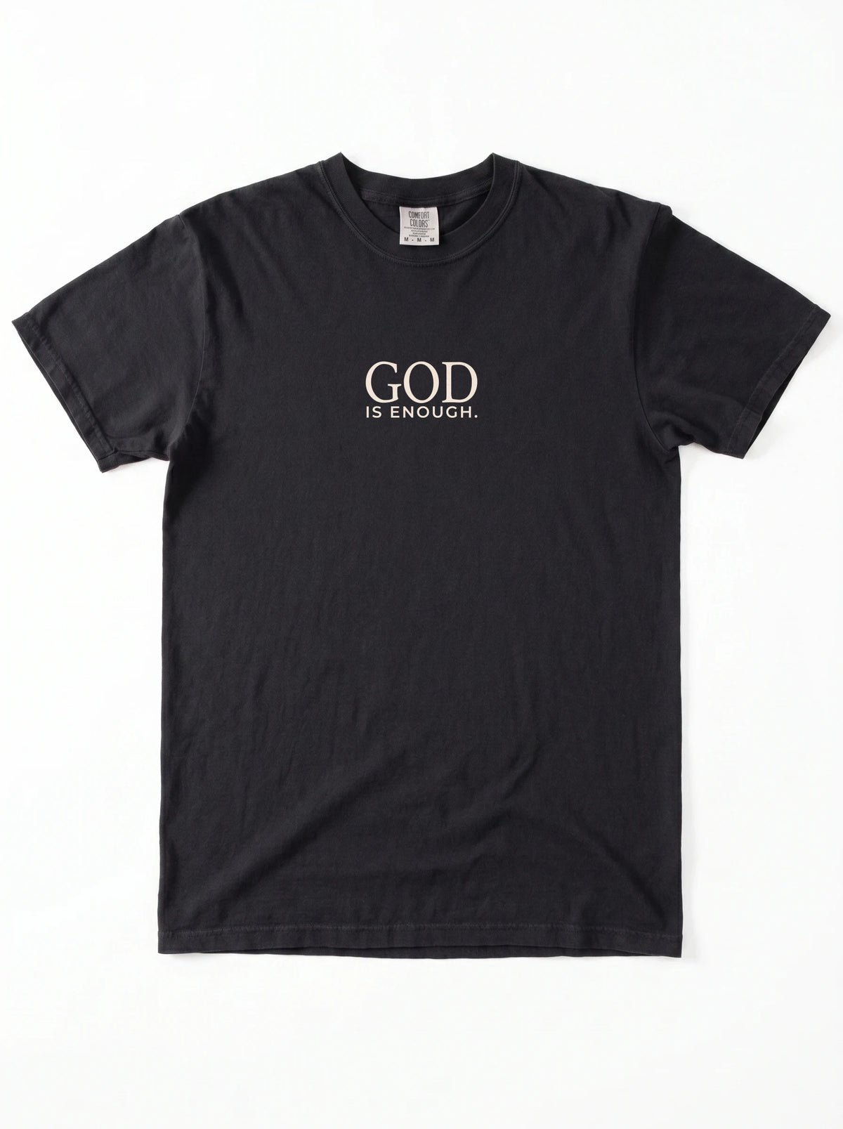 A black short-sleeve crewneck t-shirt with the words 'GOD IS ENOUGH.' printed in a light beige serif font on the chest, displayed flat against a white background.