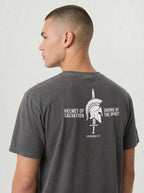 A man shown from the back wearing a dark gray t-shirt with a white graphic print of a Spartan helmet and sword, accompanied by the text 'HELMET OF SALVATION' and 'SWORD OF THE SPIRIT'.