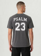 Man wearing pepper gray Comfort Colors t-shirt with Psalm 23 varsity print on the back