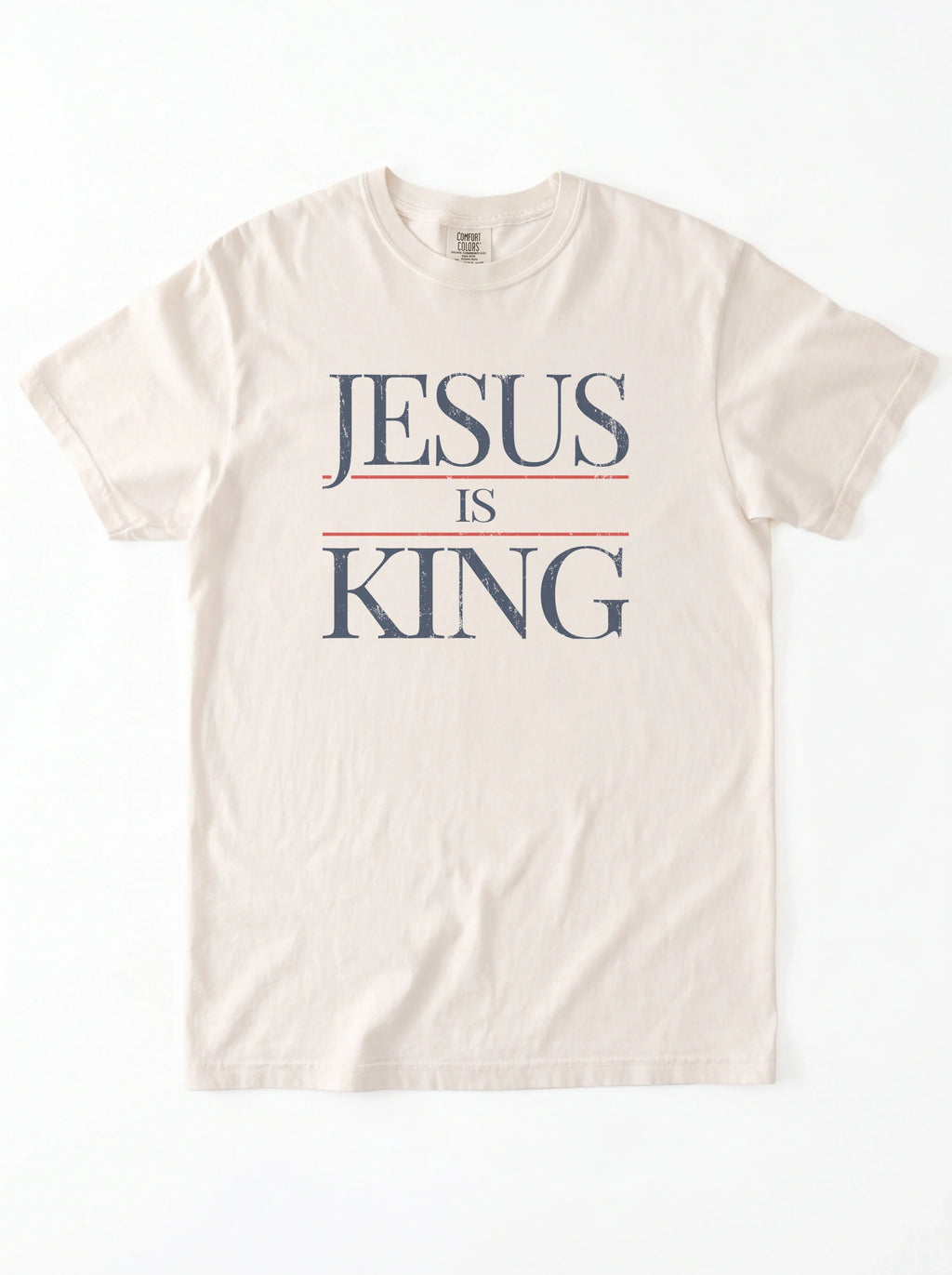 Flat lay of cream Comfort Colors Jesus Is King graphic t-shirt