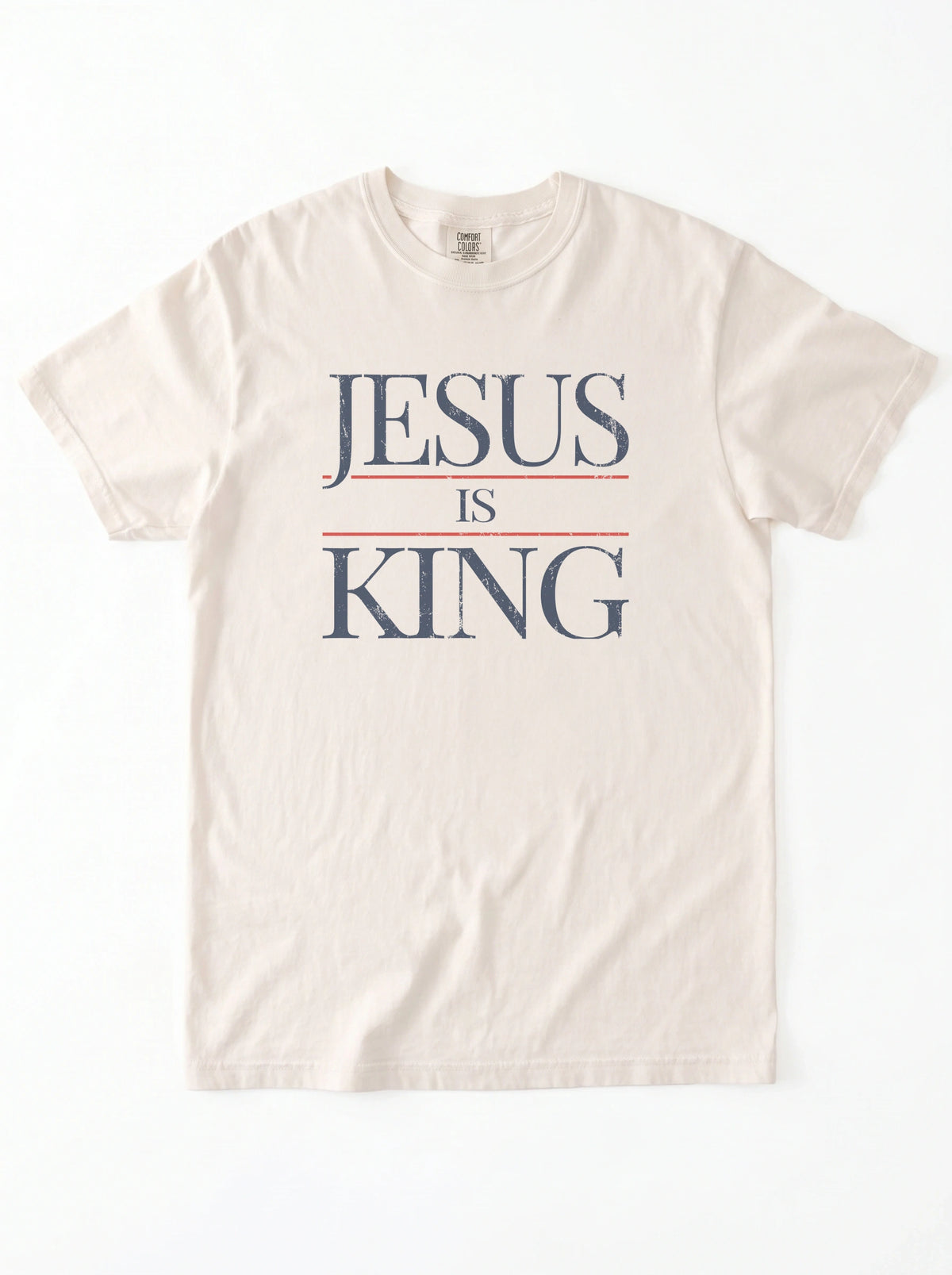 Flat lay of cream Comfort Colors Jesus Is King graphic t-shirt