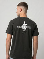 A man wearing a dark charcoal gray t-shirt, viewed from the back. The shirt features a white graphic print of a Spartan helmet and sword with the text 'HELMET OF SALVATION' and 'SWORD OF THE SPIRIT' on the back.