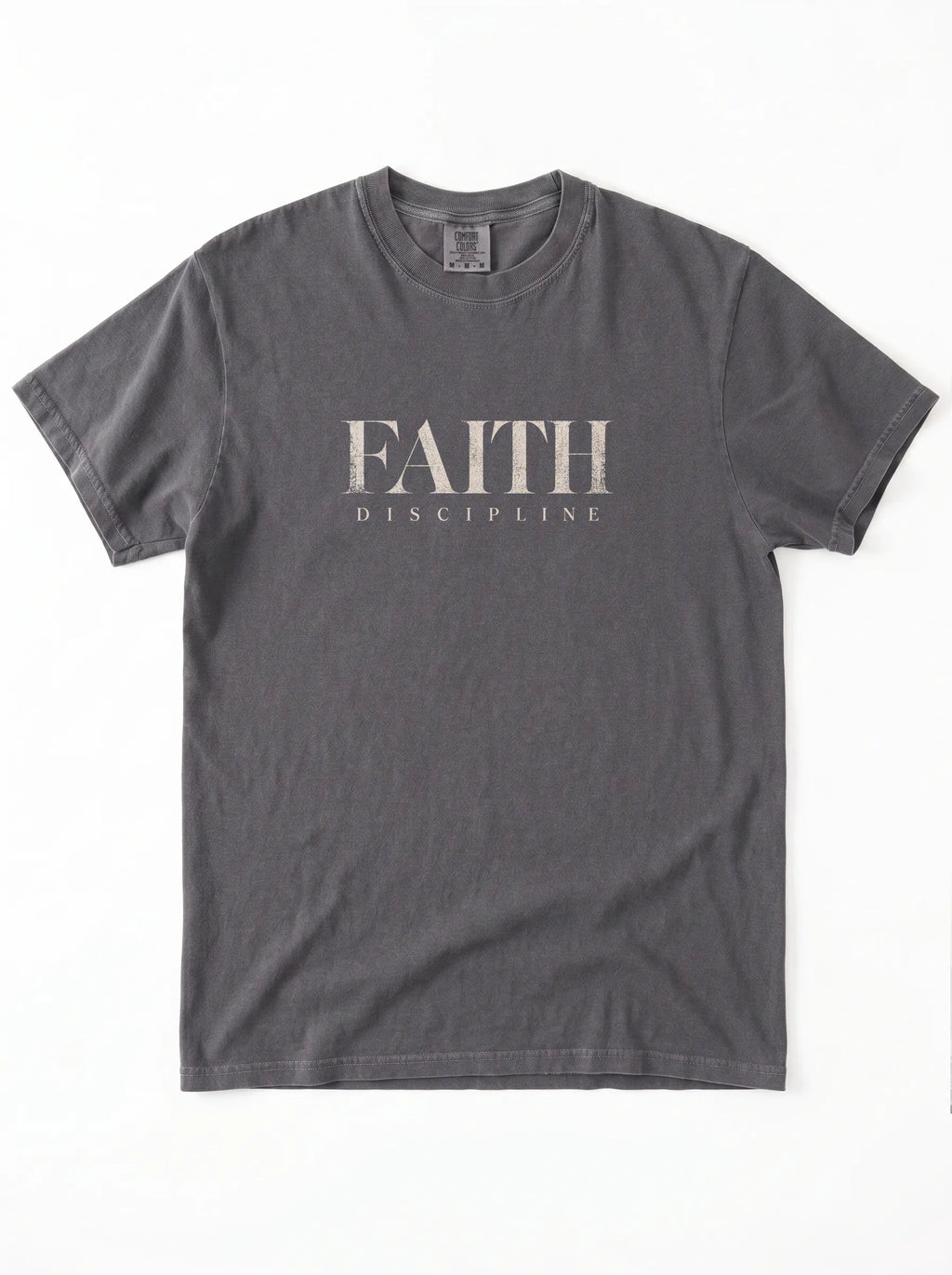 Faded charcoal T-shirt laid flat with distressed beige text reading “FAITH” and “DISCIPLINE.”