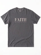 Faded charcoal T-shirt laid flat with distressed beige text reading “FAITH” and “DISCIPLINE.”