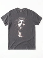 A dark gray crewneck t-shirt featuring a high-contrast graphic print of Jesus Christ's face wearing a crown of thorns, displayed flat against a white background.