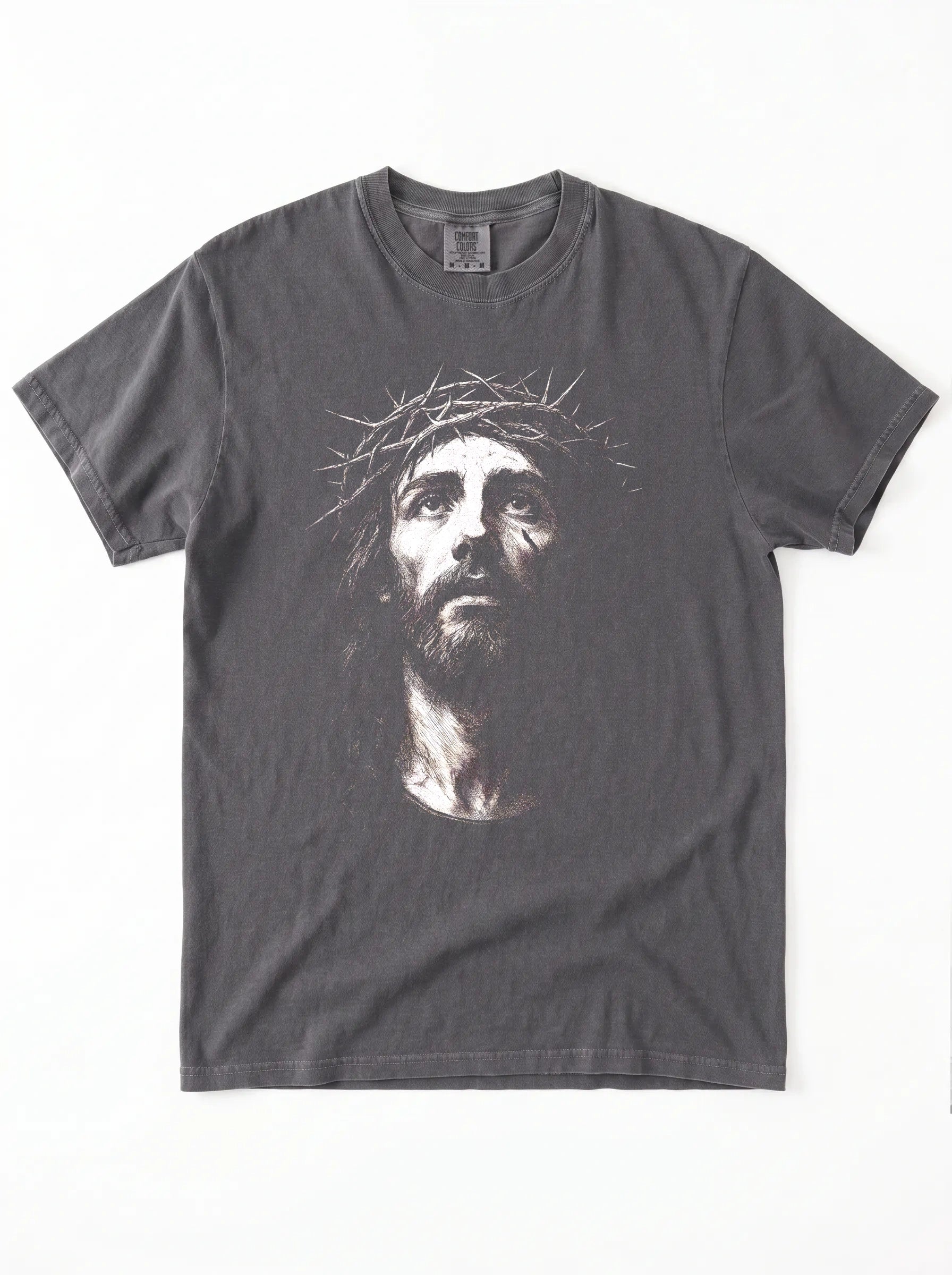 A dark gray crewneck t-shirt featuring a high-contrast graphic print of Jesus Christ's face wearing a crown of thorns, displayed flat against a white background.
