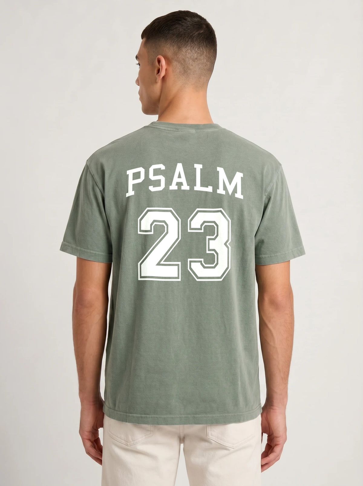 Man wearing moss green Comfort Colors t-shirt with Psalm 23 varsity print on the back