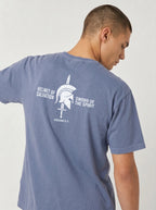 A man wearing a heathered slate blue t-shirt, viewed from the back. The shirt features a white graphic print of a Spartan helmet and sword with the text 'HELMET OF SALVATION' and 'SWORD OF THE SPIRIT' on the back.