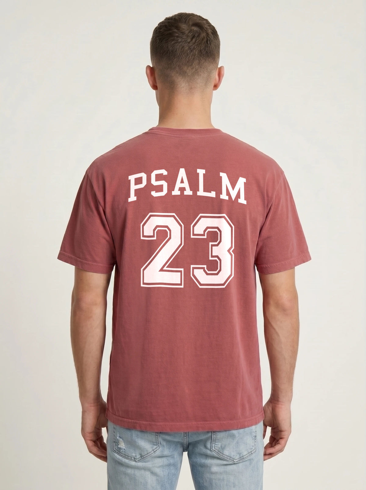 Man wearing crimson red Comfort Colors t-shirt with Psalm 23 varsity print on the back