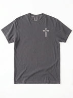 A dark gray short-sleeve crewneck t-shirt with a small white cross graphic printed on the left chest, displayed flat against a white background.