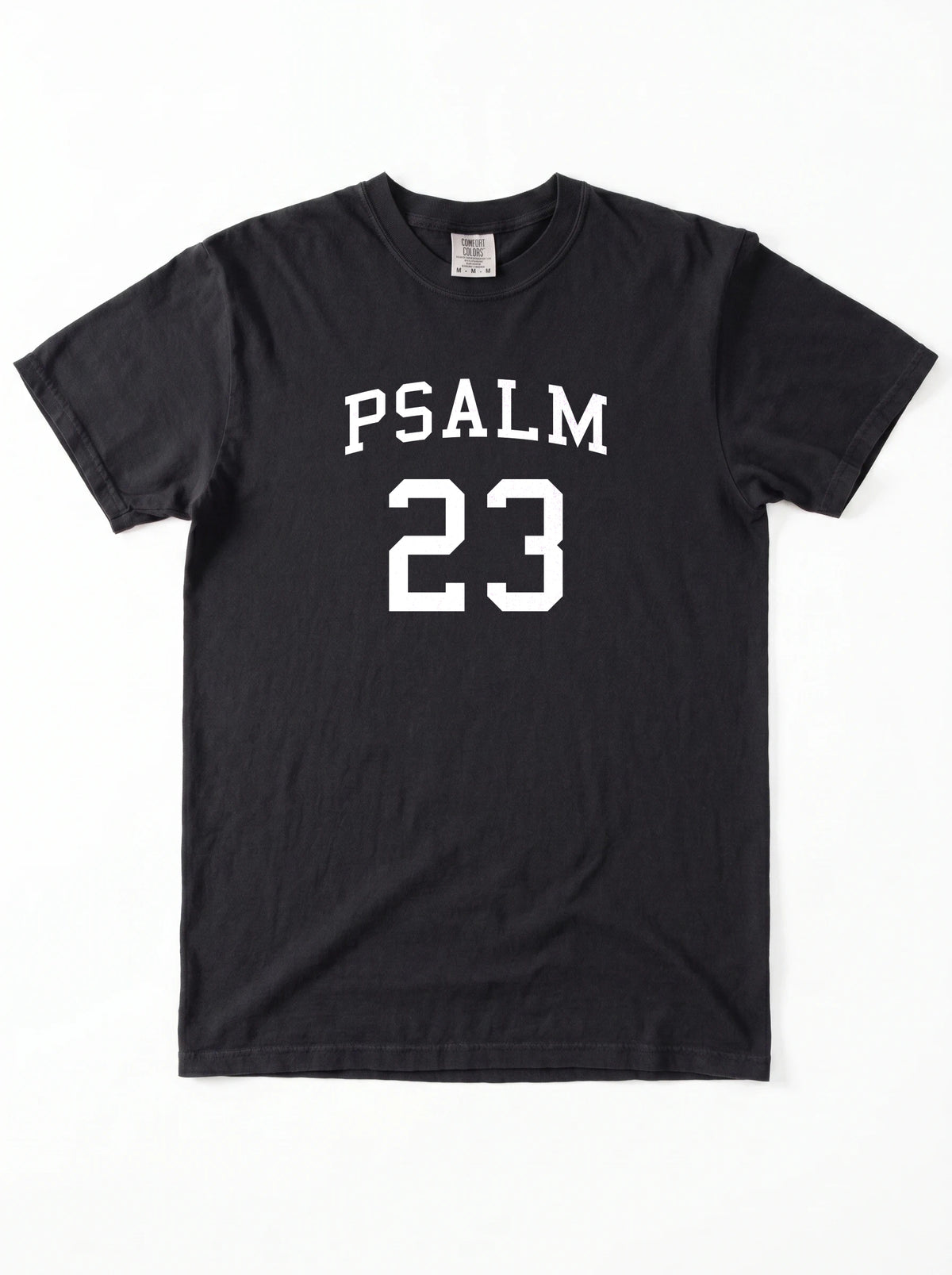 Flat lay of black Comfort Colors t-shirt, front view with Psalm 23 varsity graphic print