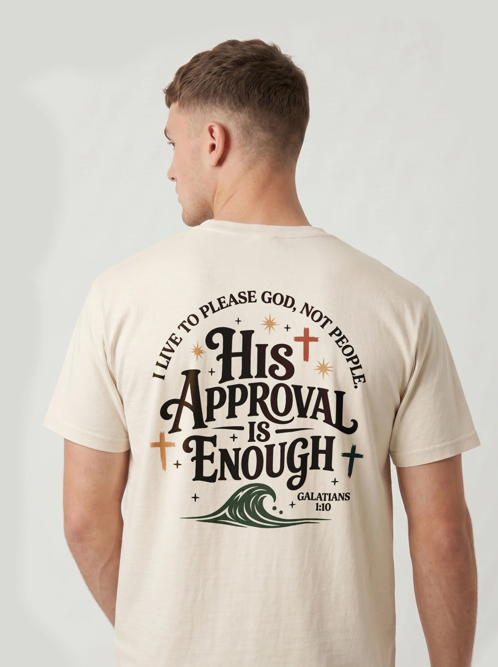 Man wearing cream Comfort Colors t-shirt with 'His Approval Is Enough' faith-based graphic design on the back, Galatians 1:10