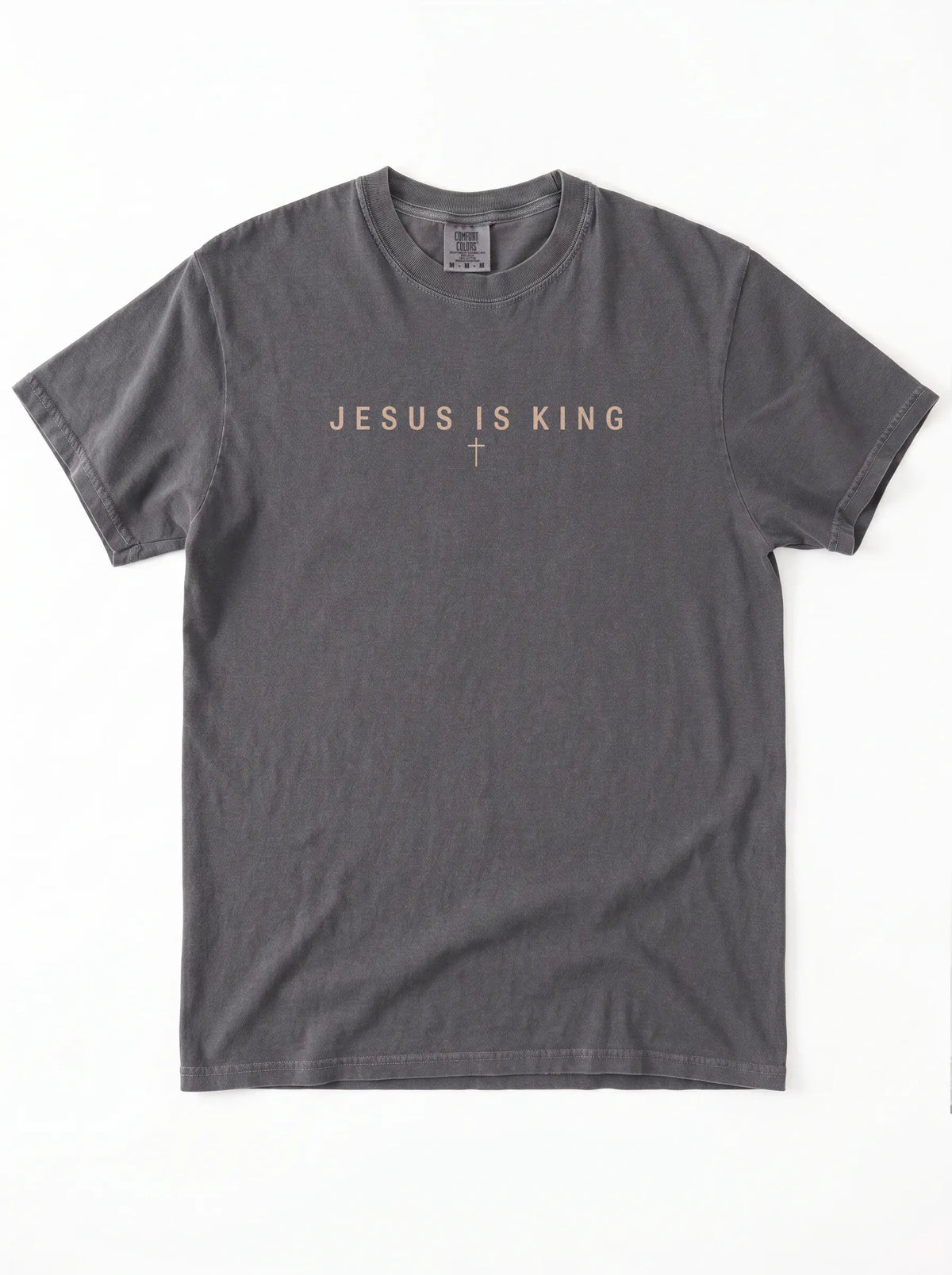 Faded charcoal T-shirt laid flat with “Jesus Is King” and a small cross printed across the chest.