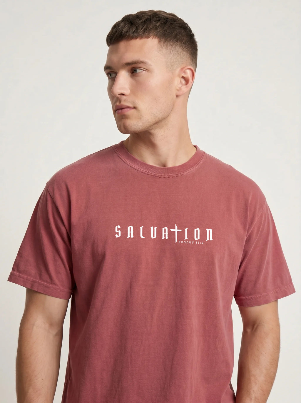 Person wearing a faded red T-shirt with white “Salvation” and “Exodus 15:2” text across the chest.