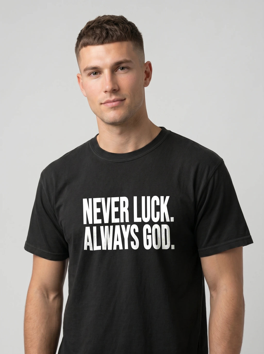 Person wearing a black T-shirt with white text reading “Never luck. Always God.”