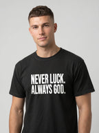 Person wearing a black T-shirt with white text reading “Never luck. Always God.”