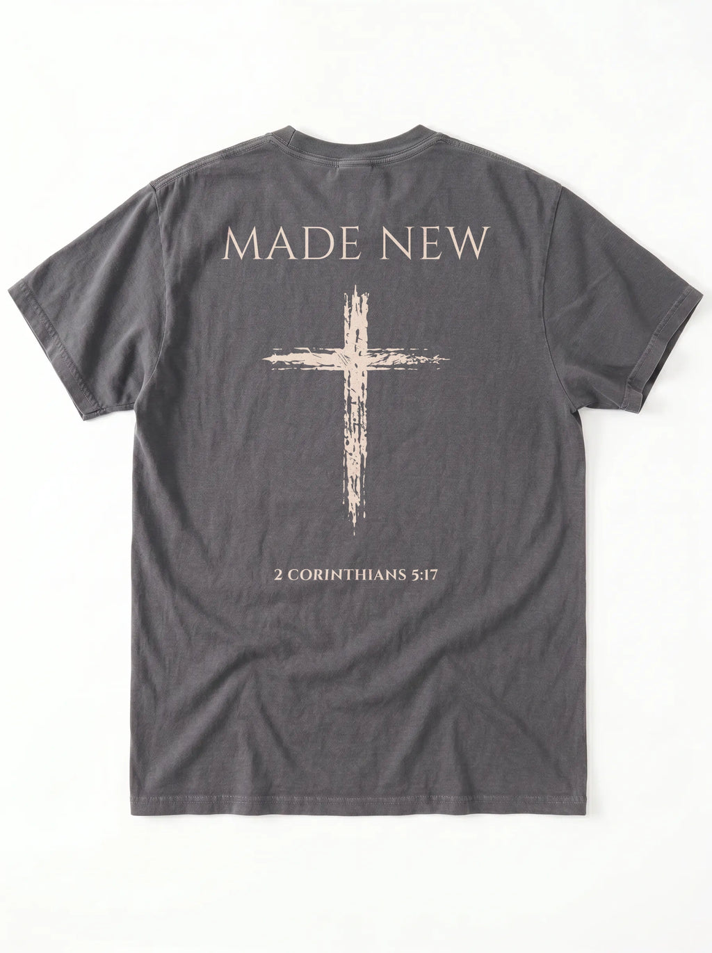 Flat lay back view of dark gray Comfort Colors tee with Made New cross design and 2 Corinthians 5:17 verse