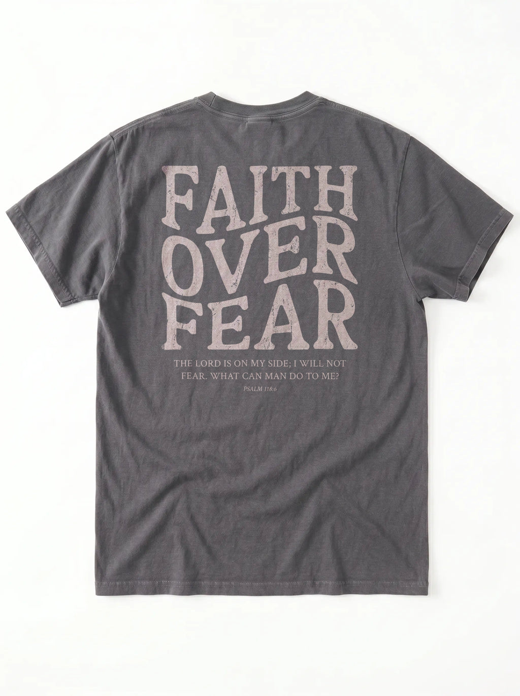 A dark gray crewneck t-shirt shown from the back, featuring a large distressed light beige graphic that reads 'FAITH OVER FEAR' with a bible verse printed underneath.