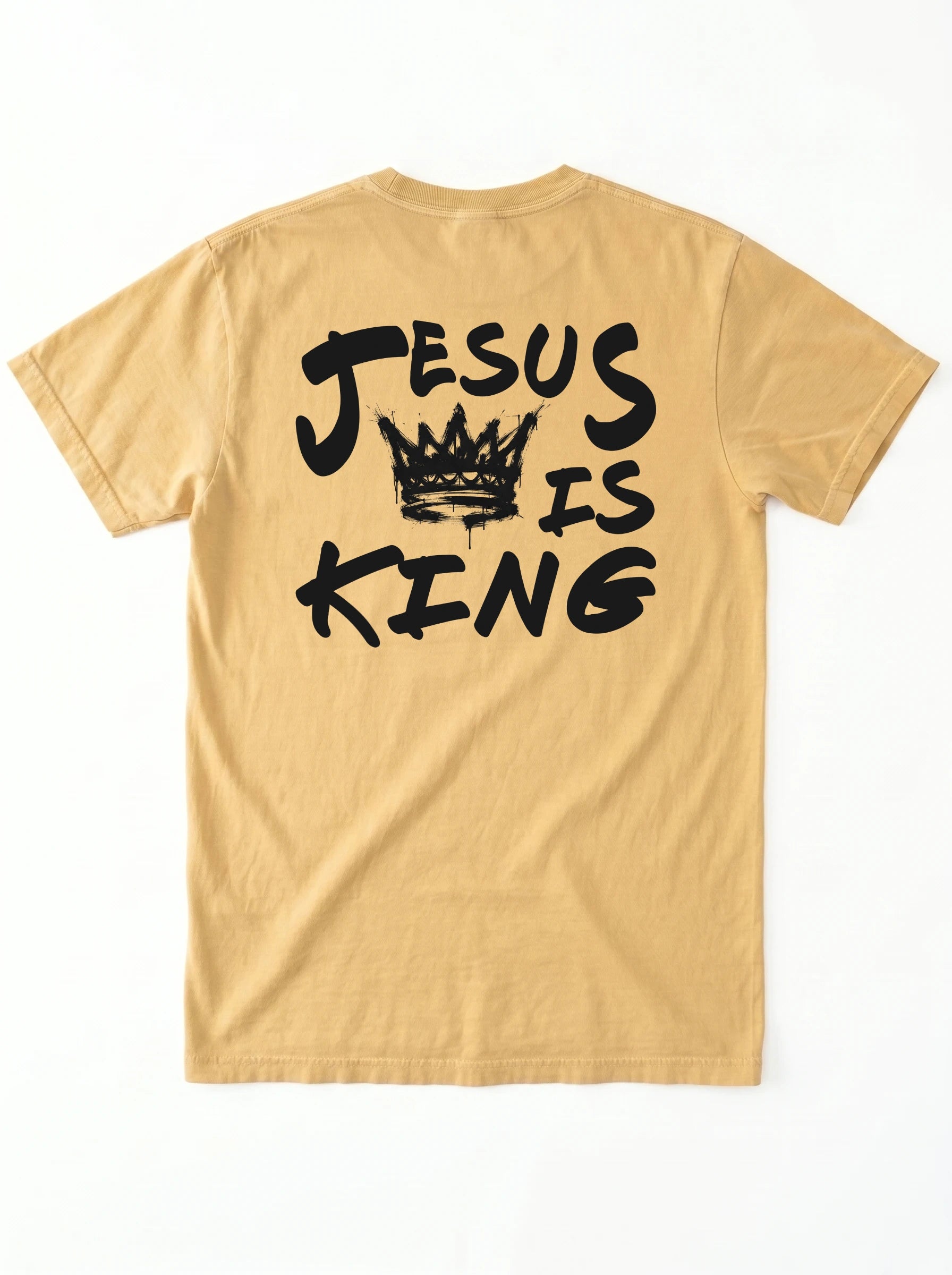 A tan short-sleeve t-shirt shown from the back, featuring a black graphic print that reads 'JESUS IS KING' with a crown illustration in the center, laid flat against a white background.