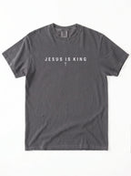 A dark gray crewneck t-shirt with the text 'JESUS IS KING' and a small cross printed on the chest, displayed flat against a white background.