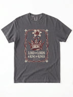 A dark gray crewneck t-shirt featuring a graphic print of a crown, a lily flower, and the text 'LORD OF LORDS & KING OF KINGS' in a distressed, vintage-style design.