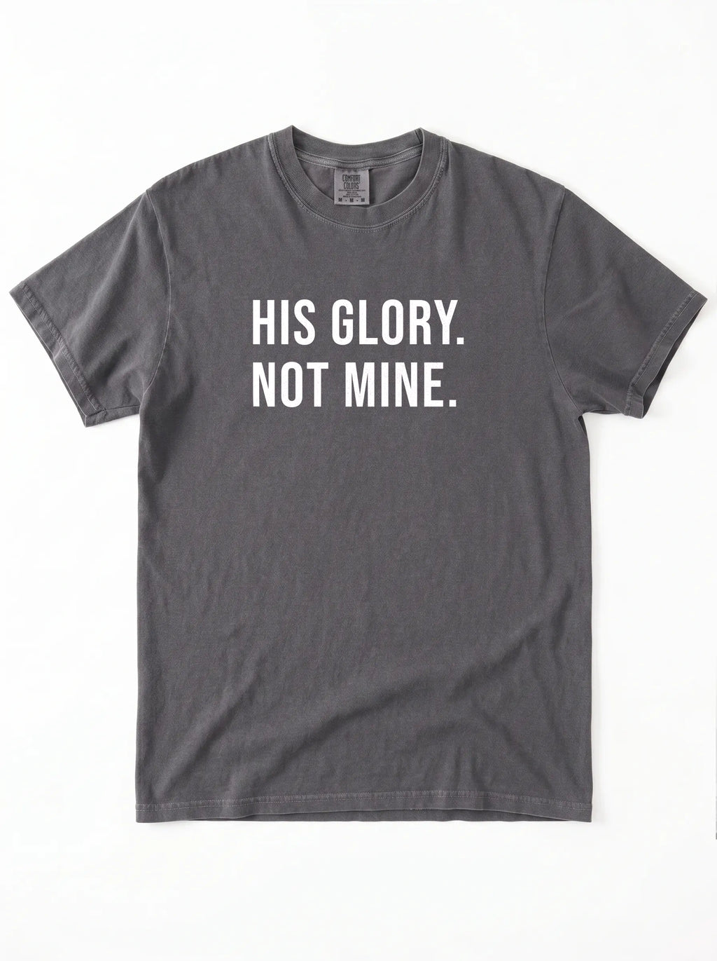 Flat lay of charcoal gray Comfort Colors 1717 garment-dyed t-shirt with 'His Glory. Not Mine.' print