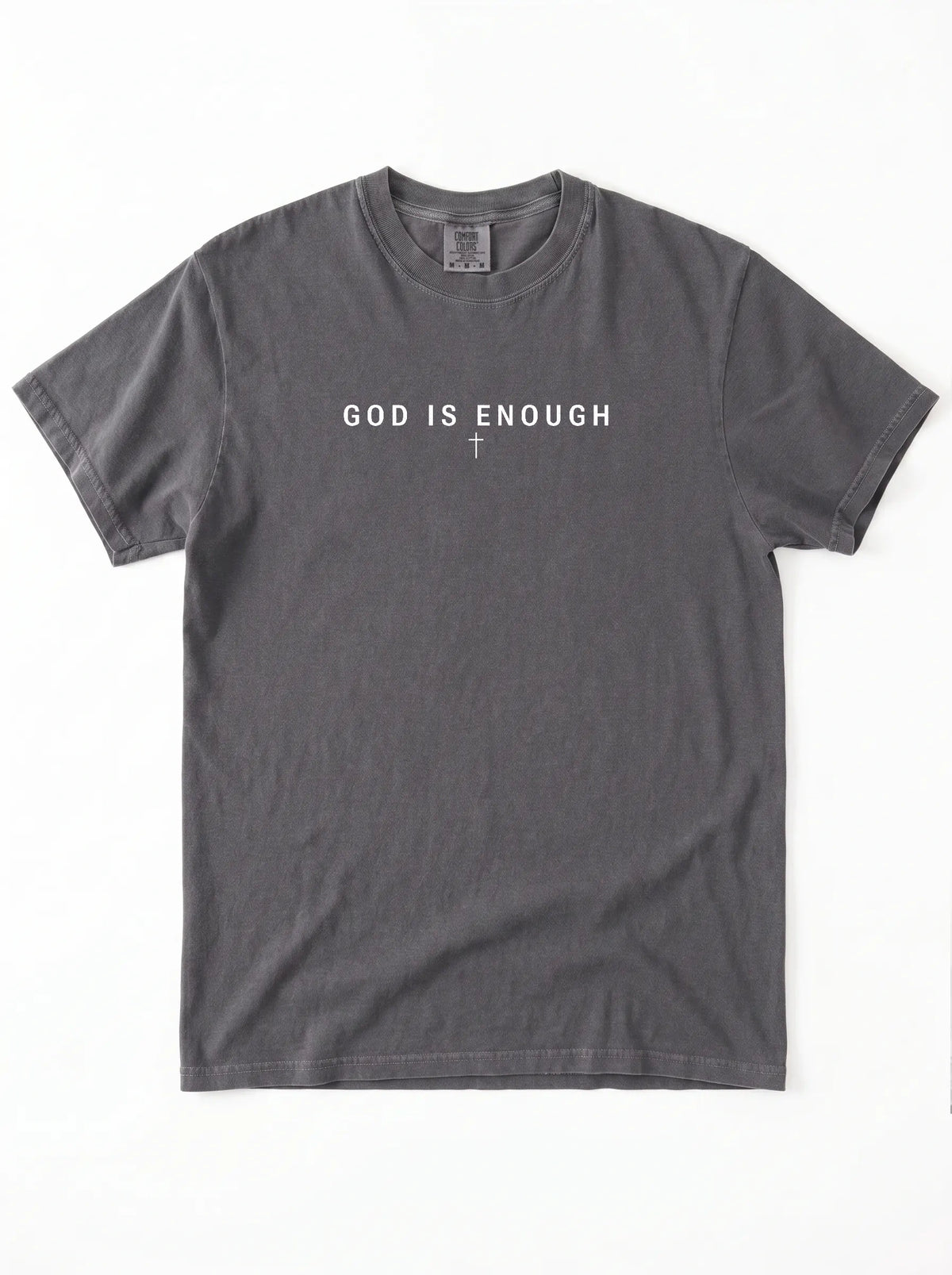 Faded charcoal T-shirt laid flat with the text “God is enough” and a small cross beneath it.