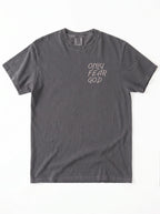 A dark gray short-sleeve t-shirt with the text 'ONLY FEAR GOD' printed in a light beige handwritten font on the left chest, displayed flat against a white background.