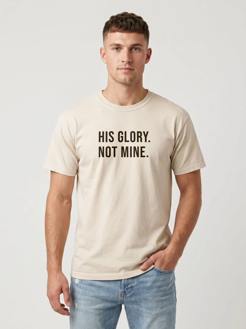 Man wearing an ivory Comfort Colors garment-dyed t-shirt printed with 'His Glory. Not Mine.' Christian faith quote
