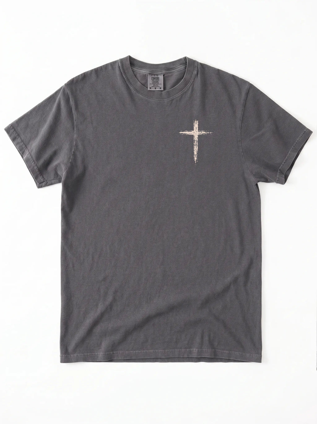 Flat lay of dark gray Comfort Colors t-shirt with distressed cross graphic on left chest