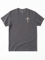 Flat lay of dark gray Comfort Colors t-shirt with distressed cross graphic on left chest