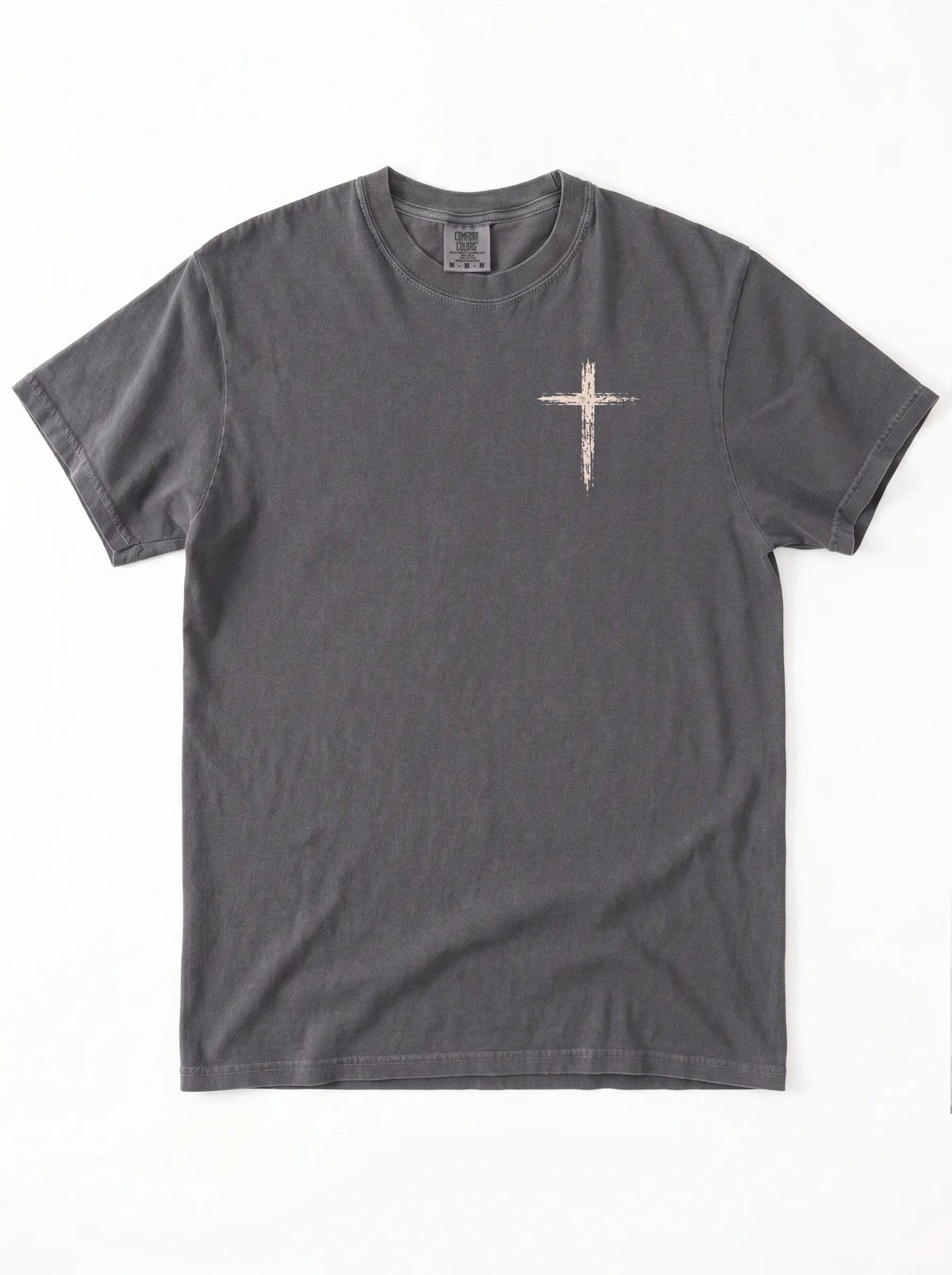Flat lay of dark gray Comfort Colors t-shirt with distressed cross graphic on left chest
