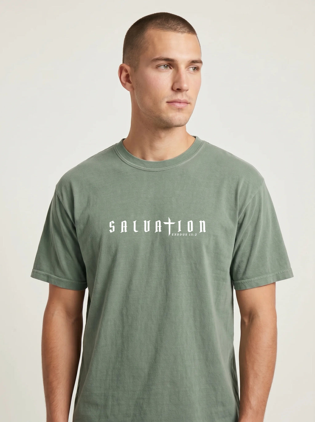 Person wearing a faded green T-shirt with white “Salvation” and “Exodus 15:2” text across the chest.