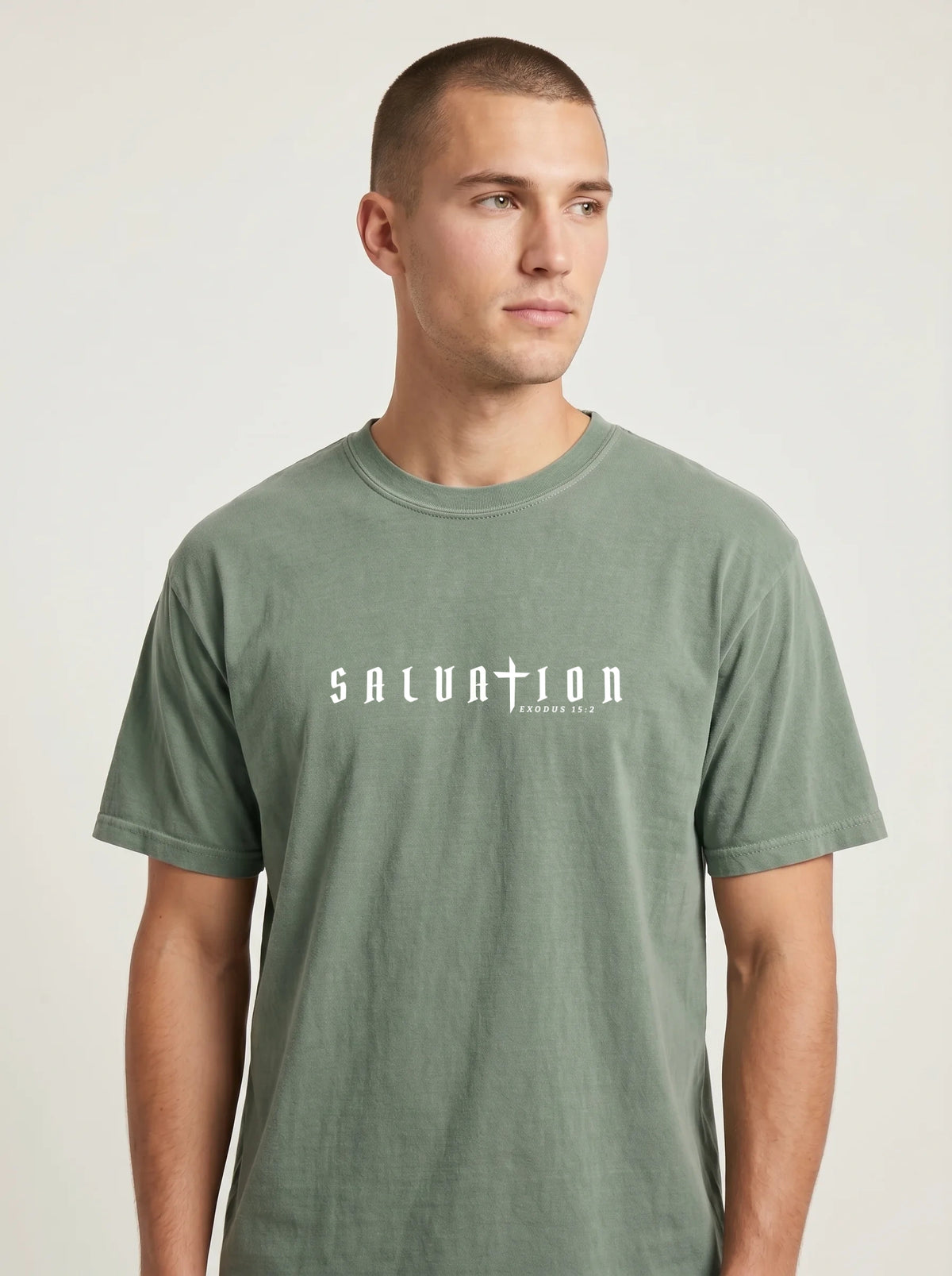 Person wearing a faded green T-shirt with white “Salvation” and “Exodus 15:2” text across the chest.