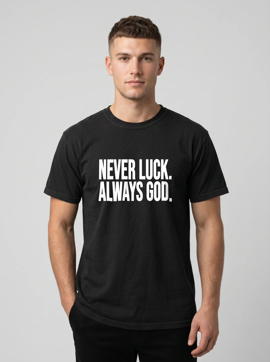 Person wearing a black T-shirt with white text reading “Never luck. Always God.”